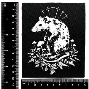 May include: Black square patch featuring a white illustration of a rat surrounded by mushrooms and foliage. Above the rat are several crosses. The patch measures approximately 4 inches by 4 inches.