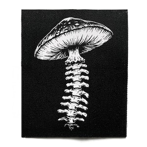 May include: A rectangular black fabric patch featuring a white screen-printed illustration of a mushroom cap attached to a human spinal column. The design uses high-contrast lines to depict the gills of the mushroom and the individual vertebrae.