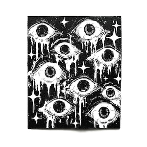 May include: Black rectangular patch with a detailed illustration of multiple stylized eyes with white tear streaks. White star shapes are scattered around the eyes. The artwork is a stark contrast of black and white.