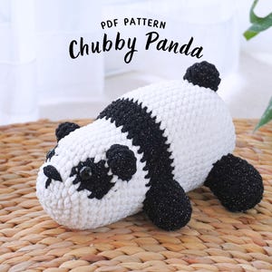May include: A crocheted panda plush toy with black and white fur. The panda is lying on a woven wicker surface. The text "PDF PATTERN Chubby Panda" is above the panda.