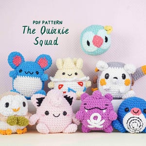 May include: A collection of handmade crochet plush toys in various colors, including blue, pink, and purple. The toys have cute, cartoonish designs and are arranged on a light pink background. The text "PDF Pattern The Quirkie Squad" is at the top.