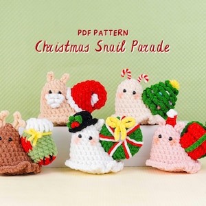 May include: A group of crocheted snail ornaments, each decorated with Christmas-themed elements. The snails are in shades of brown, white, and pink, with accessories such as Santa hats and Christmas trees. Text reads "PDF PATTERN Christmas Snail Parade."
