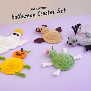 May include: A set of five crocheted Halloween coasters featuring a white ghost, a tan bat, a gray spider under a glass mug, an orange pumpkin, and a green monster with white bone-shaped limbs. The text PDF PATTERN Halloween Coaster Set is visible.