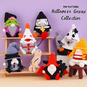 May include: A collection of seven crocheted Halloween gnomes featuring various costumes including a clown, a vampire, a ghost, and a witch. The text "PDF PATTERN Halloween Gnome Collection" is printed in the upper right corner of the image.