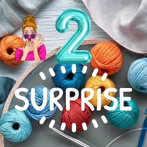 May include: A plate of colorful yarn balls with a large blue number 2 balloon and the word "SURPRISE" in white letters.