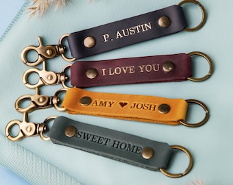 May include: Four leather keychains with gold metal rings and clasps. The keychains are personalized with the text "P. Austin", "I Love You", "Amy ♥ Josh", and "Sweet Home".
