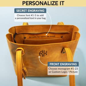 Może przedstawiać: Brązowa sk&oacute;rzana torba typu tote z kieszenią zapinaną na zamek błyskawiczny i frędzlem. Torba ma monogram "RK" z przodu i tekst "Be safe, be warm, be loved." wewnątrz kieszeni.