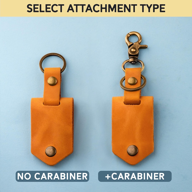 May include: Two leather keychains with a choice of attachment types: one with a metal carabiner and one without. Both keychains are tan leather with a brass ring and a brass rivet.
