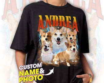 May include: Black t-shirt with a graphic of five corgi dogs in front of a lightning bolt design. The text "ANDREA" is printed in orange and yellow above the dogs. The text "CUSTOM NAME & PHOTO" is printed in yellow in the lower left corner.
