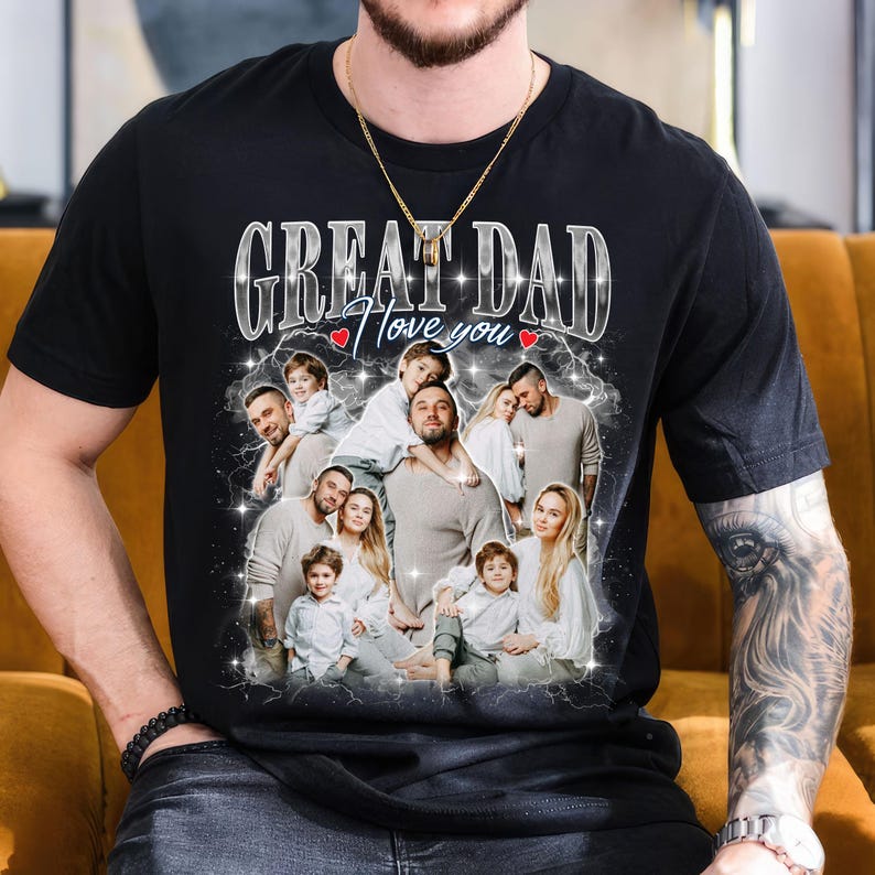 May include: Black t-shirt with a family photo design. The shirt features the text "GREAT DAD I love you" in a silver, stylized font, with a heart symbol. The design includes a family portrait with multiple people.