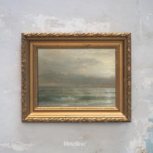 May include: An antique framed seascape painting. The artwork depicts a cloudy sky over a turbulent ocean with visible waves. The frame is ornate, gold-colored, and rectangular. The painting evokes a sense of the sea.