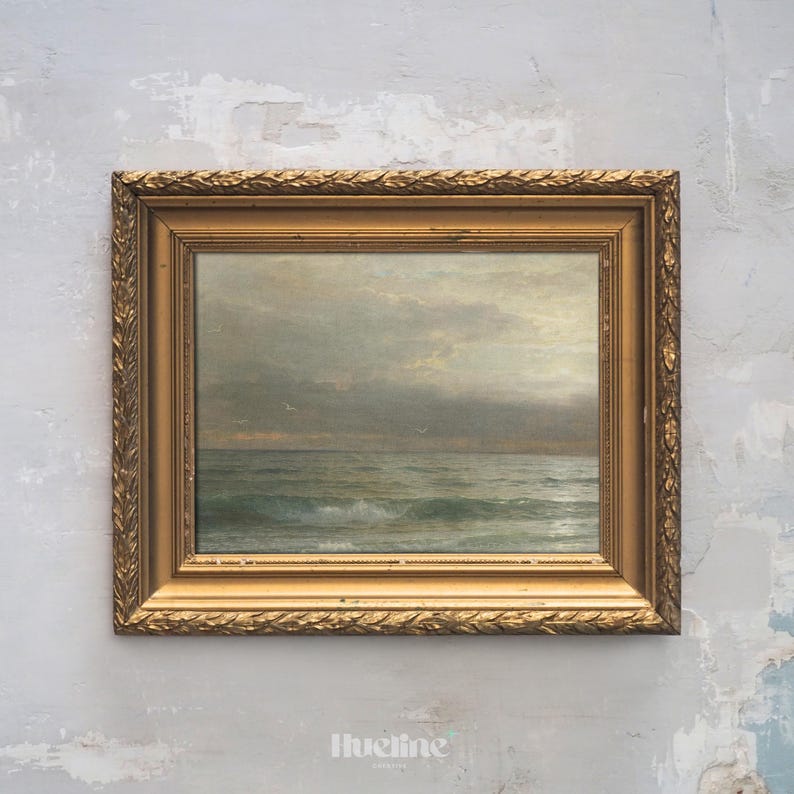 May include: An antique framed seascape painting. The artwork depicts a cloudy sky over a turbulent ocean with visible waves. The frame is ornate, gold-colored, and rectangular. The painting evokes a sense of the sea.