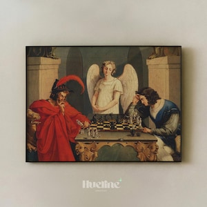 May include: Framed art print depicting a chess game between two figures, with an angel observing. One figure wears a red robe and hat, the other a blue tunic. The chess board is on a decorative table. The print is framed in black.