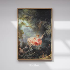 May include: A framed print of a Rococo painting showing a woman on a swing in a garden. The woman wears a pink dress, and the artwork has a natural wood frame. The scene is set in a forest with detailed foliage.