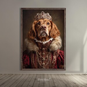 May include: A framed portrait of a dog dressed in regal attire. The dog wears a jeweled crown, a red and gold gown, and a fur collar. The artwork is displayed on a wall above a wooden floor.
