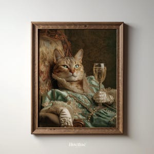 May include: A framed print featuring a regal cat in a vintage portrait style. The cat is dressed in a teal gown and holding a glass of champagne. The artwork has a brown wooden frame and is set against a neutral background.