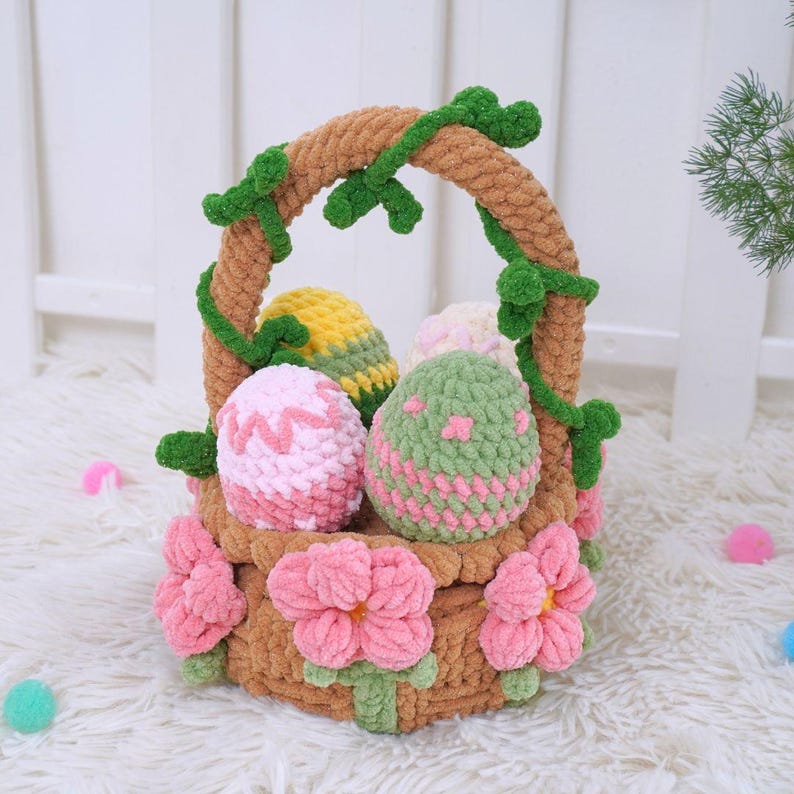 May include: A crocheted Easter basket with a brown base and green vines. The basket is filled with pink, green, and yellow crocheted eggs. The basket is decorated with pink crocheted flowers.