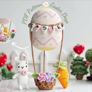 May include: A crocheted Easter egg hot air balloon with a bunny and carrot in the basket. The balloon is decorated with a banner that says "EASTER".