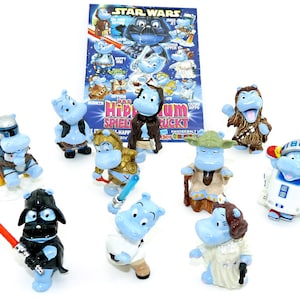 May include: A set of nine blue hippopotamus figurines dressed as characters from the Star Wars movie franchise. The figurines are hand-painted and feature details like lightsabers, blasters, and iconic costumes. The set includes characters like Darth Vader, Yoda, Chewbacca, and R2-D2.