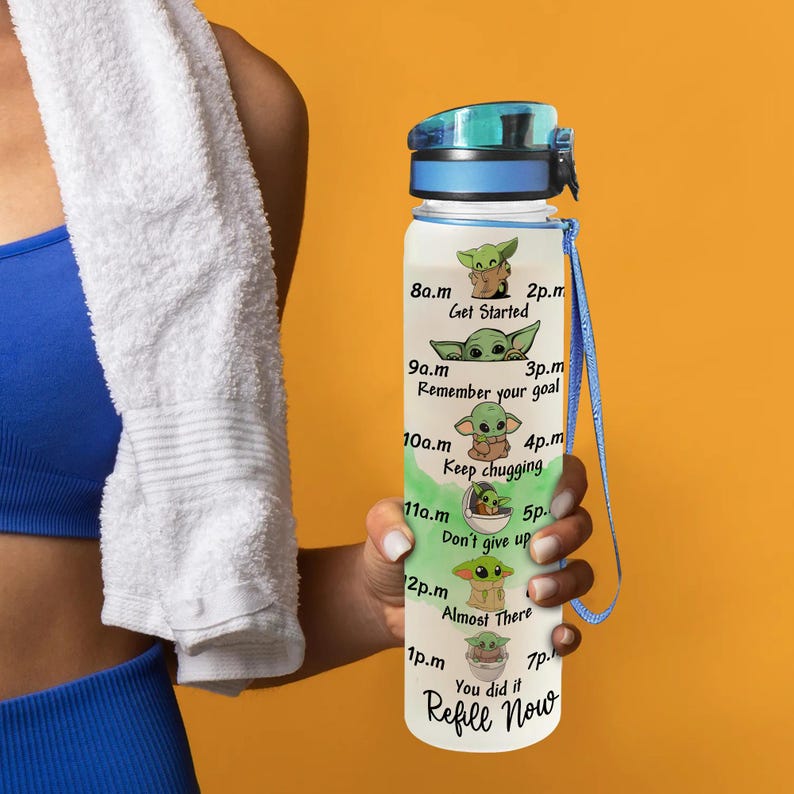 May include: A clear water bottle with a green and white design featuring a cartoon character. The bottle has a blue lid and a blue strap. The bottle has text that reads "8a.m Get Started" and "Refill Now".