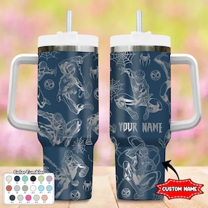 May include: A navy blue tumbler featuring a repeating pattern of Spider-Man in various action poses and spiderwebs. The tumbler has a white handle, lid, and straw. The text "YOUR NAME" is visible on the side, with a "CUSTOM NAME" label.