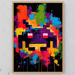 May include: Abstract art print featuring a pixelated alien design in a vibrant array of colors. The artwork showcases a black background with splashes of orange, yellow, blue, and purple, framed in a wooden frame.