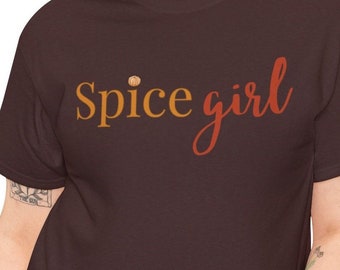 May include: A brown t-shirt with the text "Spice girl" in orange and red lettering.