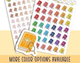 May include: Two sticker sheets and one individual die-cut sticker featuring illustrations of books with an eye and sunburst design on the cover, accompanied by a string of beads. The stickers appear in various colors including red, blue, and yellow.