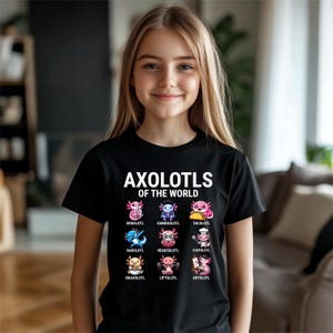 May include: Black t-shirt featuring the text "AXOLOTLS OF THE WORLD" above colorful cartoon axolotl illustrations. Each axolotl is uniquely designed with different themes, including a chef, a taco, and a gamer.