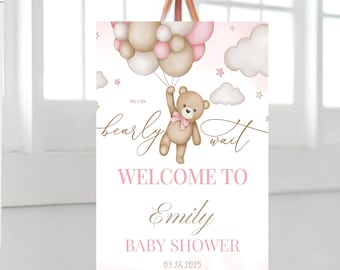 May include: A pink and brown baby shower welcome sign with a teddy bear holding balloons. The sign says "We can bearly wait" and "Welcome to Emily Baby Shower 03.28.2025".
