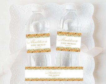 May include: Two clear plastic water bottles with white caps and labels. The labels feature the name "Maddison" in gold script, with "BABY SHOWER" and the date 05.28.2023. The labels are decorated with a floral border in shades of yellow and orange.