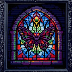 May include: A framed cross-stitch artwork featuring a stained-glass window design. The window depicts a moth with a colorful wing pattern in shades of purple, red, blue, and green. The frame is black and ornate, adding a gothic aesthetic.
