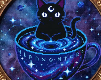 May include: A circular cross-stitch embroidery featuring a black cat with a crescent moon mark on its forehead sitting inside a teacup filled with a swirling blue galaxy. The wooden frame is engraved with runic symbols around the edge.