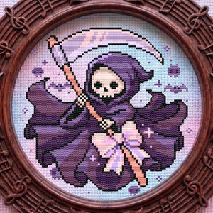 May include: A framed cross-stitch featuring a pixelated Grim Reaper in a purple cloak, holding a scythe. The artwork is set within a brown, oval frame adorned with musical notes and bow details. The background is a pastel blend of pink and blue.