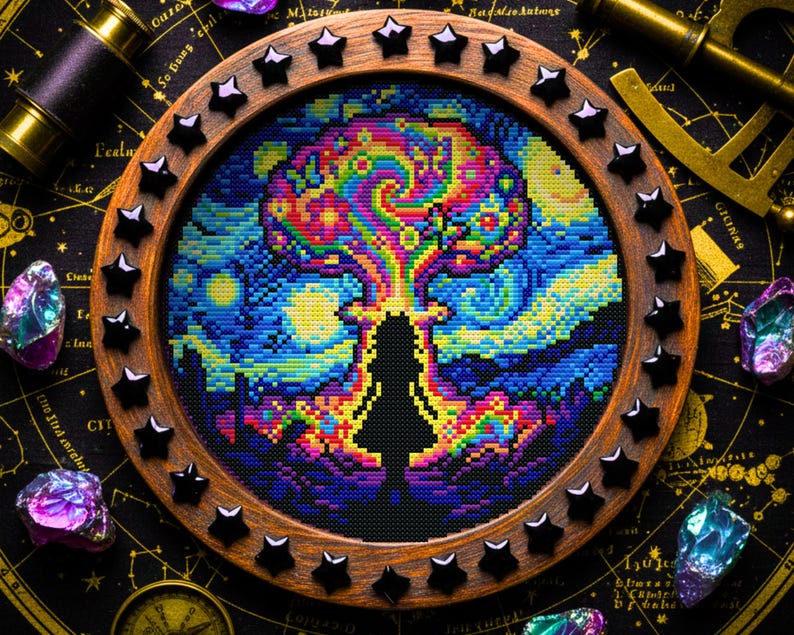 May include: A cross-stitch artwork in a circular wooden frame, depicting a person's silhouette with a vibrant, swirling design above. The frame is decorated with black star-shaped embellishments. The background includes a starry night sky and gemstones.