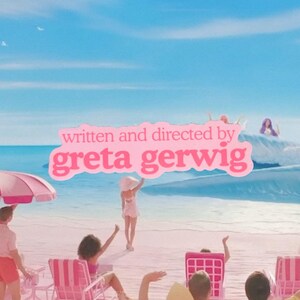 May include: A pastel pink beach scene with people, beach chairs, and an umbrella. The text "written and directed by greta gerwig" is displayed in a pink bubble. The sky is a bright blue.