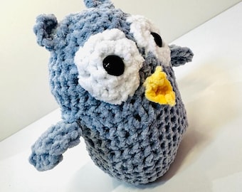 May include: A crocheted gray owl plush toy with white eyes and a yellow beak.
