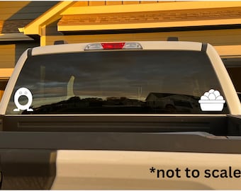 May include: White vinyl decal of a cartoon character with a surprised expression and a basket of white eggs on a black truck window. *not to scale*.