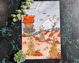 May include: A watercolor painting of a small orange and brown house with a chimney in a field of pumpkins and corn stalks. The house has a window and a fence in front of it. The background is a light blue sky with a full moon and bats flying.