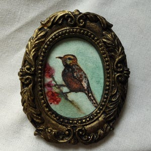 Small watercolor painting of a bird, little bird painted in a handmade golden vintage-style frame, 8.5 x 7 cm