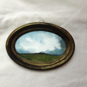 Small oil painting of a landscape in a handmade vintage-style oval frame, 17 x 12 cm