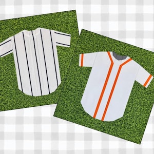May include: Two baseball jerseys on a green background. One is white with navy blue vertical stripes. The other is white with orange stripes and trim. Both have short sleeves and a rounded hem.