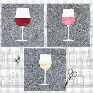 May include: Three wine glasses with different colored wine. The glasses are on a gray background with a white polka dot pattern. The glasses are all the same shape and size.