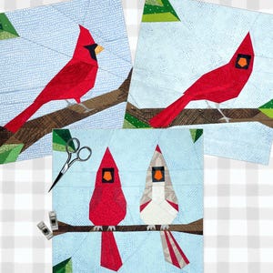 May include: Three paper pieced cardinal bird quilt blocks. Two blocks feature a red cardinal on a branch with green leaves. The third block features a red cardinal and a white cardinal on a branch with green leaves.