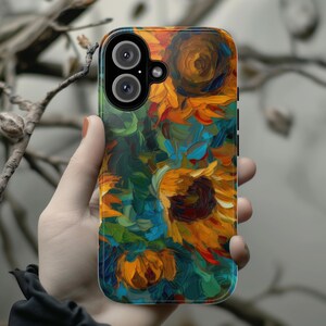 May include: A phone case with a colorful abstract painting of sunflowers. The case has a cutout for the camera lens.