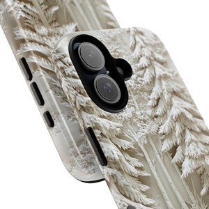 May include: A white phone case featuring a wintery forest scene. The case has an embossed design of snow-covered pine trees. The phone case has a black camera lens cutout.