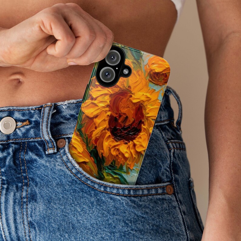 May include: A phone case with a vibrant sunflower painting design. The case has a clear back and a black frame. The sunflower is painted in a thick, textured style, with yellow petals and a dark brown center.