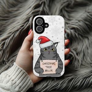 May include: A white phone case with a black cat wearing a red Santa hat and holding a sign that says "Christmas Tree Killer". The background is white with snowflakes.
