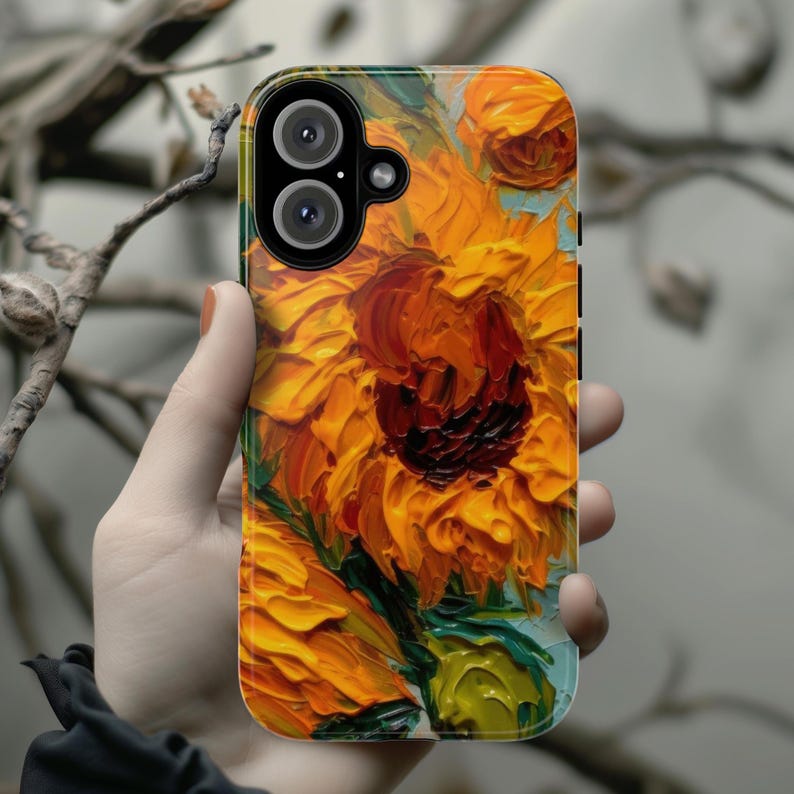 May include: A phone case with a vibrant sunflower painting. The case features a close-up of a sunflower with yellow petals and a dark brown center. The background is a light blue with hints of green.