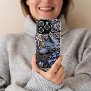 May include: A blue and gold phone case with a wolf design. The wolf is in a detailed, almost 3D style, with gold accents. The case has a floral pattern in the background.